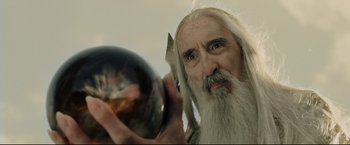 Movie still from “The Lord of the Rings: The Return of the King” (2003), directed by Peter Jackson – An old man with a long white beard holding a crystal ball; Close Up shot, Over the shoulder angle