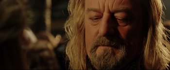 Movie still from “The Lord of the Rings: The Return of the King” (2003), directed by Peter Jackson – A person with long hair and a beard; Close Up shot, Over the shoulder angle