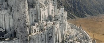 Movie still from “The Lord of the Rings: The Return of the King” (2003), directed by Peter Jackson – An aerial view of a city with many buildings; Extreme Wide shot, Overhead angle