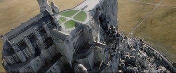 Movie still from “The Lord of the Rings: The Return of the King” (2003), directed by Peter Jackson – An aerial view of a castle with a green lawn; Extreme Wide shot, High angle