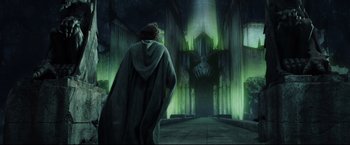 Movie still from “The Lord of the Rings: The Return of the King” (2003), directed by Peter Jackson – A man wearing a robe and a cape in front of a cathedral; Wide shot, Low angle