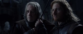 Movie still from “The Lord of the Rings: The Return of the King” (2003), directed by Peter Jackson – Two people holding a sword in a dark room; Close Up shot, Low angle
