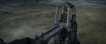 Movie still from “The Lord of the Rings: The Return of the King” (2003), directed by Peter Jackson – An image of a man standing on a bridge; Extreme Wide shot, High angle