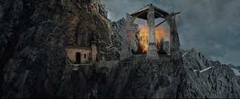 Movie still from “The Lord of the Rings: The Return of the King” (2003), directed by Peter Jackson – An image of a fire burning in the middle of a mountain; Extreme Wide shot, High angle