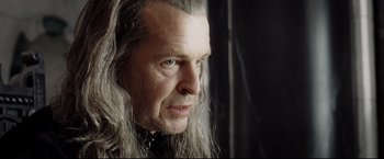 Movie still from “The Lord of the Rings: The Return of the King” (2003), directed by Peter Jackson – An older man with long grey hair stares into the camera; Close Up shot, Over the shoulder angle