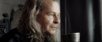 Movie still from “The Lord of the Rings: The Return of the King” (2003), directed by Peter Jackson – An older man with long hair and a beard; Close Up shot, Over the shoulder angle