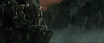 Movie still from “The Lord of the Rings: The Return of the King” (2003), directed by Peter Jackson – A man standing on top of a cliff; Wide shot, High angle