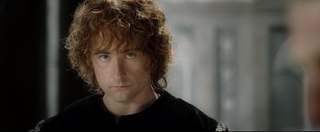 Movie still from “The Lord of the Rings: The Return of the King” (2003), directed by Peter Jackson – A person wearing a black shirt; Close Up shot, Low angle
