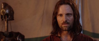 Movie still from “The Lord of the Rings: The Return of the King” (2003), directed by Peter Jackson – A person with long hair and a beard; Close Up shot, Over the shoulder angle