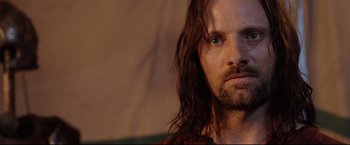 Movie still from “The Lord of the Rings: The Return of the King” (2003), directed by Peter Jackson – A person with long hair and a beard; Close Up shot, Low angle