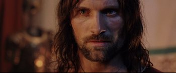 Movie still from “The Lord of the Rings: The Return of the King” (2003), directed by Peter Jackson – A person with long hair and a beard; Close Up shot, Low angle
