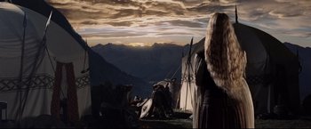Movie still from “The Lord of the Rings: The Return of the King” (2003), directed by Peter Jackson – A woman standing in front of a teepee on top of a hill; Wide shot, Low angle