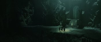 Movie still from “The Lord of the Rings: The Return of the King” (2003), directed by Peter Jackson – A group of people standing next to each other in a cave; Extreme Wide shot, High angle