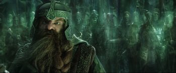 Movie still from “The Lord of the Rings: The Return of the King” (2003), directed by Peter Jackson – An image of a man in a costume in the middle of a forest; Medium shot, Low angle
