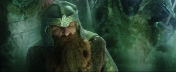 Movie still from “The Lord of the Rings: The Return of the King” (2003), directed by Peter Jackson – A person with a beard wearing a helmet; Close Up shot, Low angle