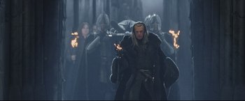 Movie still from “The Lord of the Rings: The Return of the King” (2003), directed by Peter Jackson – A group of men in costume holding torches in the dark; Medium shot, Low angle