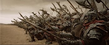 Movie still from “The Lord of the Rings: The Return of the King” (2003), directed by Peter Jackson – A group of men in armor and helmets are standing in a field; Wide shot, High angle
