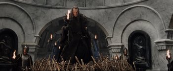 Movie still from “The Lord of the Rings: The Return of the King” (2003), directed by Peter Jackson – A man standing in front of a bunch of candles; Wide shot, Low angle