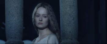 Movie still from “The Lord of the Rings: The Return of the King” (2003), directed by Peter Jackson – A woman standing next to a pillar in the dark; Close Up shot, Low angle