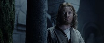 Movie still from “The Lord of the Rings: The Return of the King” (2003), directed by Peter Jackson – A person standing next to a pole; Close Up shot, Over the shoulder angle