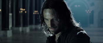 Movie still from “The Lord of the Rings: The Return of the King” (2003), directed by Peter Jackson – A person with long dark hair; Close Up shot, Low angle