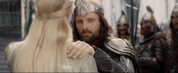 Movie still from “The Lord of the Rings: The Return of the King” (2003), directed by Peter Jackson – A man wearing a crown and holding a woman's hand; Close Up shot, Over the shoulder angle