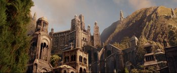 Movie still from “The Lord of the Rings: The Return of the King” (2003), directed by Peter Jackson – An old castle with many towers and a castle on top of a hill; Extreme Wide shot, Low angle