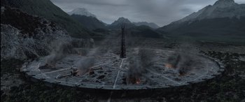 Movie still from “The Lord of the Rings: The Two Towers” (2002), directed by Peter Jackson – An aerial view of a desolate area with mountains in the background; Extreme Wide shot, High angle