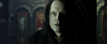 Movie still from “The Lord of the Rings: The Two Towers” (2002), directed by Peter Jackson – A person with long black hair; Close Up shot, Over the shoulder angle