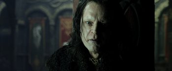 Movie still from “The Lord of the Rings: The Two Towers” (2002), directed by Peter Jackson – A person with long black hair; Close Up shot, Over the shoulder angle