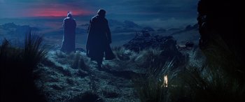 Movie still from “The Lord of the Rings: The Two Towers” (2002), directed by Peter Jackson – Two people are walking on a hill at night; Wide shot, Low angle