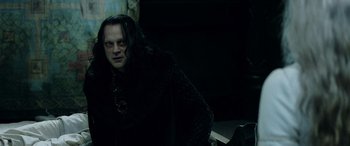 Movie still from “The Lord of the Rings: The Two Towers” (2002), directed by Peter Jackson – A man in a black robe and a black cape; Medium shot, Low angle