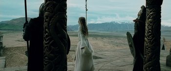 Movie still from “The Lord of the Rings: The Two Towers” (2002), directed by Peter Jackson – A woman in a white dress is standing in front of mountains; Wide shot, Low angle