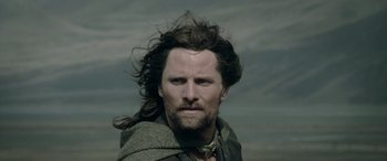 Movie still from “The Lord of the Rings: The Two Towers” (2002), directed by Peter Jackson – A person with long brown hair; Close Up shot, Low angle