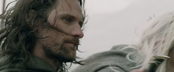 Movie still from “The Lord of the Rings: The Two Towers” (2002), directed by Peter Jackson – A person with long hair and a beard; Close Up shot, Over the shoulder angle