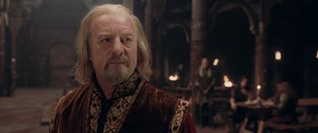 Movie still from “The Lord of the Rings: The Two Towers” (2002), directed by Peter Jackson – An older man with a long white beard; Close Up shot, Over the shoulder angle