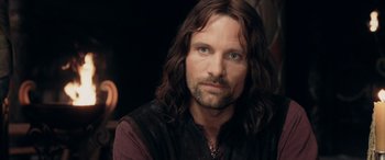 Movie still from “The Lord of the Rings: The Two Towers” (2002), directed by Peter Jackson – A person with long brown hair; Close Up shot, Over the shoulder angle
