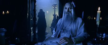 Movie still from “The Lord of the Rings: The Two Towers” (2002), directed by Peter Jackson – An old man with long white hair and a long white beard; Medium shot, Over the shoulder angle