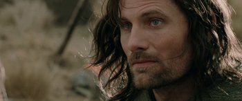 Movie still from “The Lord of the Rings: The Two Towers” (2002), directed by Peter Jackson – A person with long hair; Close Up shot, Over the shoulder angle