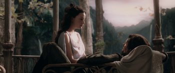 Movie still from “The Lord of the Rings: The Two Towers” (2002), directed by Peter Jackson – A woman sitting on a chair in front of a forest; Medium shot, High angle