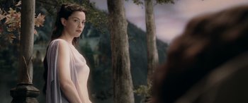 Movie still from “The Lord of the Rings: The Two Towers” (2002), directed by Peter Jackson – A woman standing in front of a forest; Medium shot, Over the shoulder angle