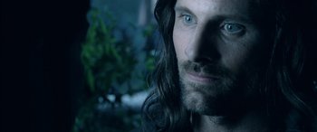 Movie still from “The Lord of the Rings: The Two Towers” (2002), directed by Peter Jackson – A person with long hair; Close Up shot, Over the shoulder angle