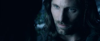 Movie still from “The Lord of the Rings: The Two Towers” (2002), directed by Peter Jackson – A person with long hair and a beard; Close Up shot, Over the shoulder angle