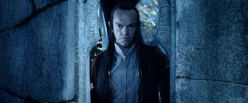 Movie still from “The Lord of the Rings: The Two Towers” (2002), directed by Peter Jackson – A person standing in front of a tree; Medium shot, Low angle