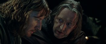 Movie still from “The Lord of the Rings: The Two Towers” (2002), directed by Peter Jackson – Two men looking at each other in a dark room; Close Up shot, Over the shoulder angle