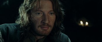 Movie still from “The Lord of the Rings: The Two Towers” (2002), directed by Peter Jackson – A person with long brown hair; Close Up shot, Over the shoulder angle