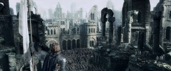 Movie still from “The Lord of the Rings: The Two Towers” (2002), directed by Peter Jackson – A crowd of people standing in front of a castle; Extreme Wide shot, High angle