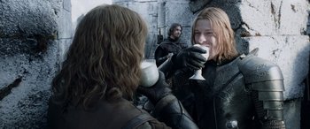 Movie still from “The Lord of the Rings: The Two Towers” (2002), directed by Peter Jackson – Two people drinking from cups in front of a mirror; Medium shot, Over the shoulder angle