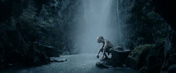 Movie still from “The Lord of the Rings: The Two Towers” (2002), directed by Peter Jackson – An image of a creature in the middle of a waterfall; Wide shot, High angle