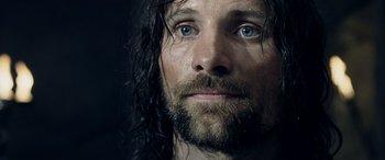 Movie still from “The Lord of the Rings: The Two Towers” (2002), directed by Peter Jackson – A person with wet hair and blue eyes; Close Up shot, Low angle